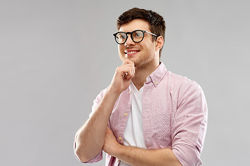 Image showing smiling young man in glasses over grey background