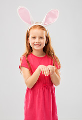 Image showing happy red haired girl wearing easter bunny ears