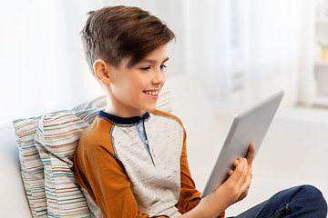 Image showing smiling boy with tablet pc computer at home