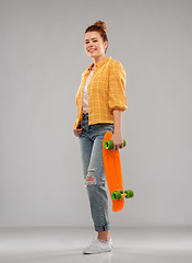 Image showing red haired teenage girl with short skateboard