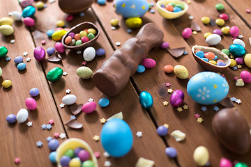 Image showing chocolate eggs, easter bunny and candies on wood