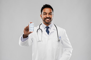 Image showing indian male doctor with pills and stethoscope