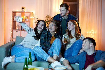 Image showing happy friends taking selfie by smartphone at home