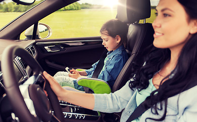 Image showing happy woman with little child driving in car