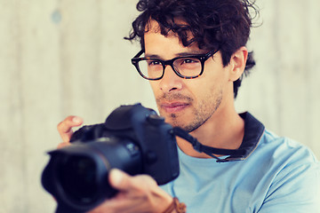 Image showing photographer with digital camera shooting in city