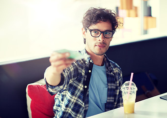 Image showing happy man with cash money paying at cafe