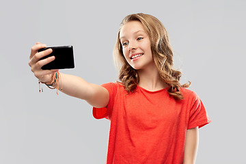 Image showing smiling teenage girl taking selfie by smartphone