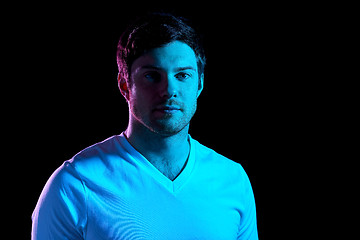 Image showing portrait of man over neon lights in dark room