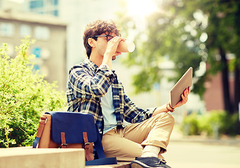 Image showing man with tablet pc and coffee on city street bench