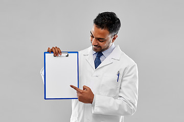 Image showing doctor or scientist with white paper on clipboard