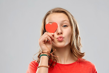 Image showing teenage girl covering eye with red heart