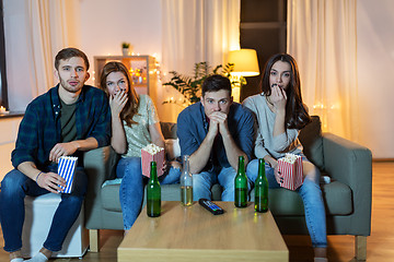 Image showing friends with beer and popcorn watching tv at home