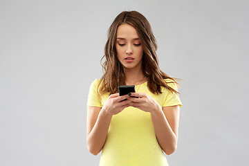 Image showing young woman or teenage girl using smartphone