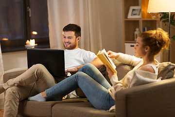 Image showing couple with laptop computer and book at home