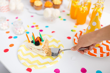 Image showing hand putting piece of birthday cake on plate