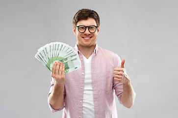 Image showing happy young man with euro money showing thumbs up