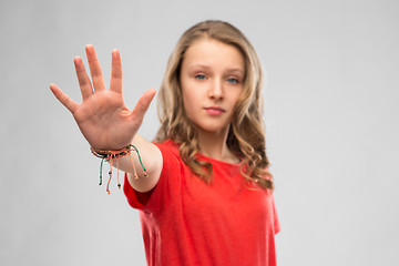 Image showing serious teenage girl showing stop gesture