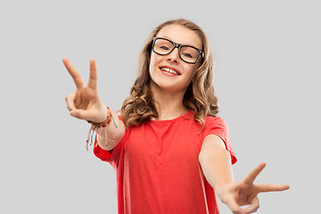 Image showing smiling student girl in glasses showing peace