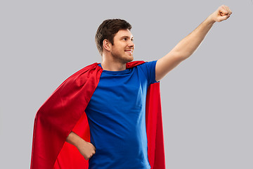 Image showing man in red superhero cape over grey background