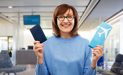 Image showing senior woman with passport and airplane ticket