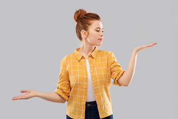 Image showing red haired teenage girl holding empty hands