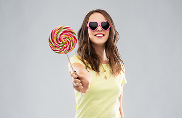 Image showing teenage girl in sunglasses with lollipop