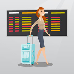 Image showing Caucasian woman walking with suitcase at airport.