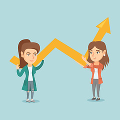 Image showing Two young business women holding growth graph.