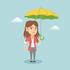 Image showing Caucasian insurance agent standing under umbrella.