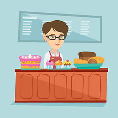 Image showing Worker standing behind the counter in the bakery.