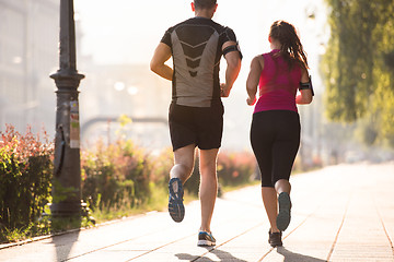 Image showing young couple jogging  in the city