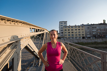 Image showing portrait of a jogging woman at sunny morning