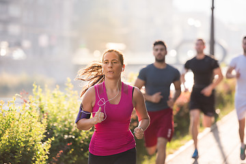 Image showing group of young people jogging in the city