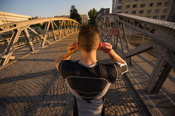 Image showing portrait of a jogging man at sunny morning