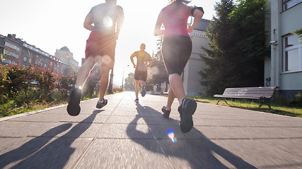 Image showing group of young people jogging in the city