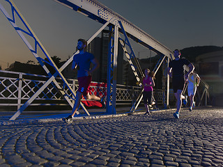 Image showing young people jogging across the bridge