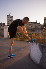 Image showing man tying running shoes laces