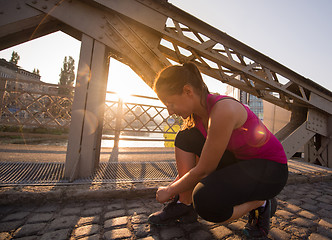 Image showing woman tying running shoes laces