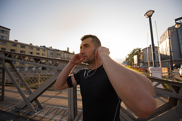 Image showing portrait of a jogging man at sunny morning