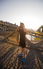 Image showing portrait of a jogging man at sunny morning