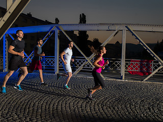 Image showing young people jogging across the bridge