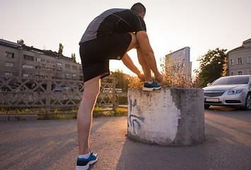 Image showing man tying running shoes laces