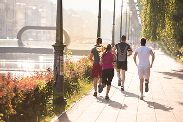 Image showing group of young people jogging in the city