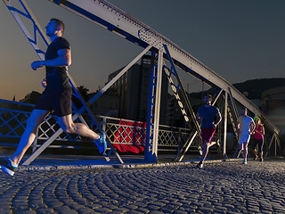 Image showing young people jogging across the bridge