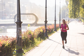 Image showing woman jogging at sunny morning