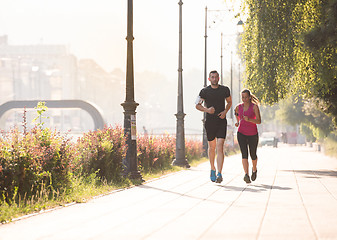 Image showing young couple jogging  in the city