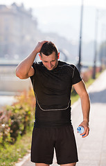 Image showing man pouring water from bottle on his head