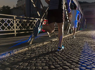 Image showing young people jogging across the bridge