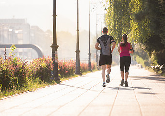 Image showing young couple jogging  in the city