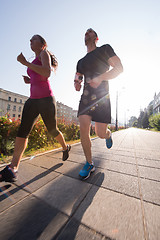 Image showing young couple jogging  in the city